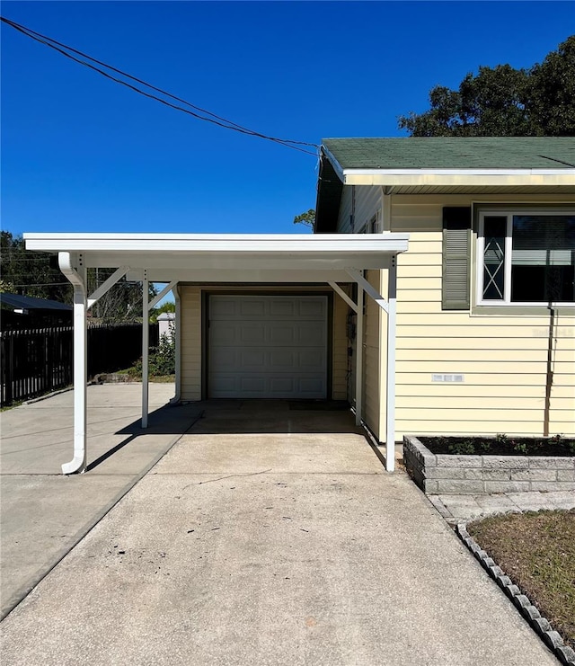 view of property exterior featuring a carport and a garage