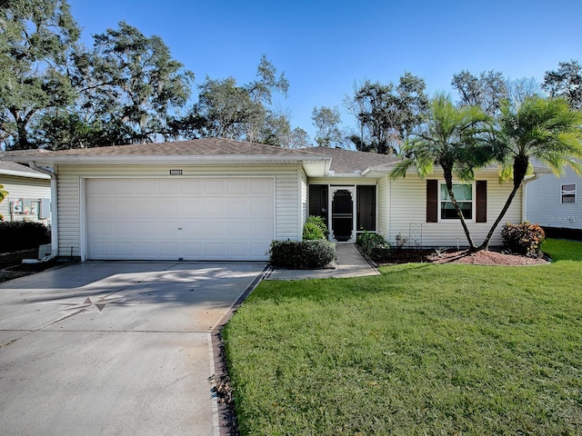 ranch-style home featuring a garage and a front lawn