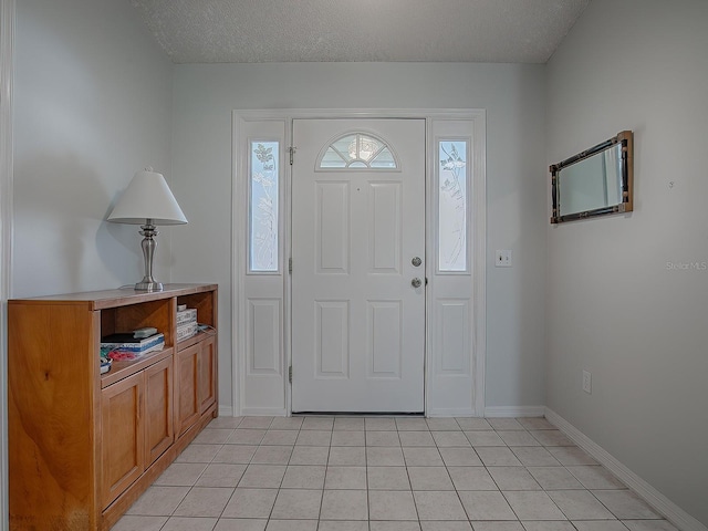 foyer featuring a textured ceiling and light tile patterned flooring