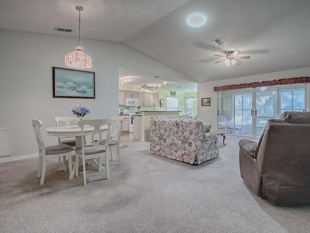 carpeted living room with ceiling fan, a textured ceiling, and vaulted ceiling