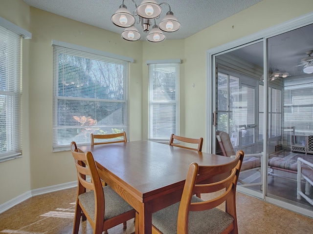 dining area featuring a textured ceiling and an inviting chandelier