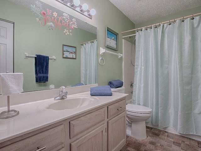 bathroom featuring vanity, a textured ceiling, and toilet