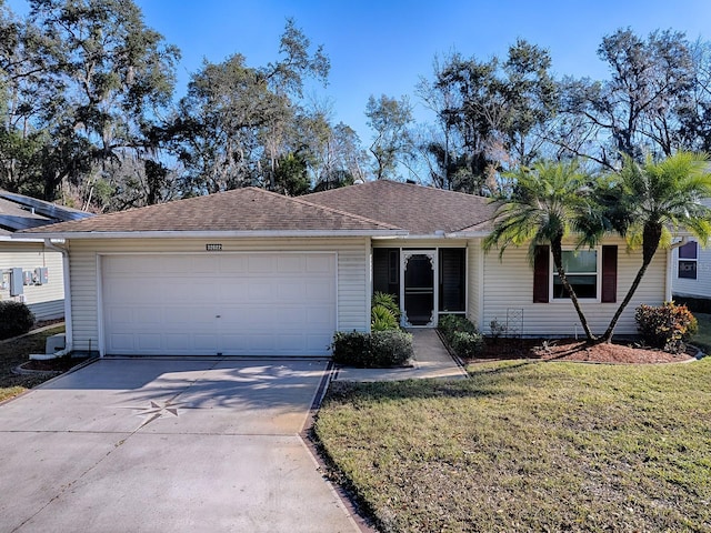 ranch-style house with a garage and a front yard