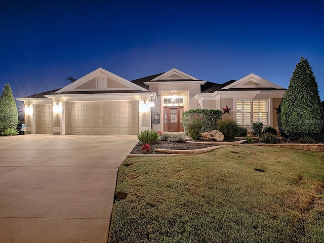 ranch-style house featuring a lawn and a garage