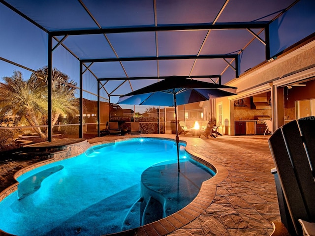 pool at dusk with area for grilling, a lanai, and a patio area