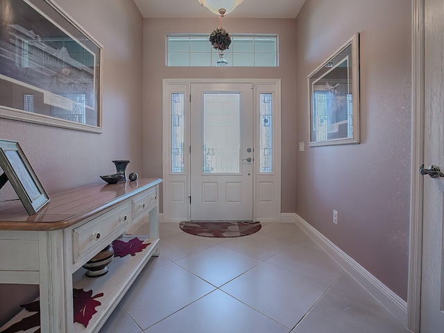 foyer entrance with light tile patterned floors