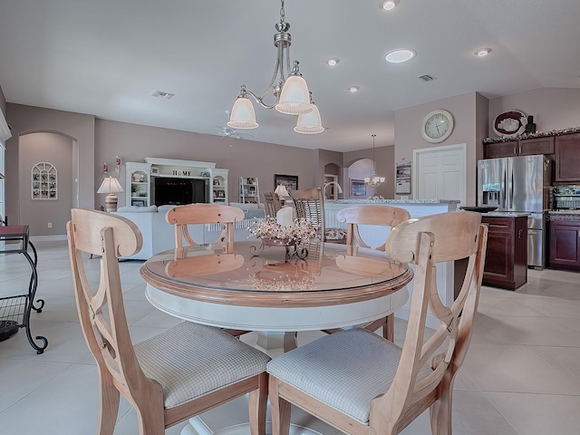 tiled dining room featuring a notable chandelier