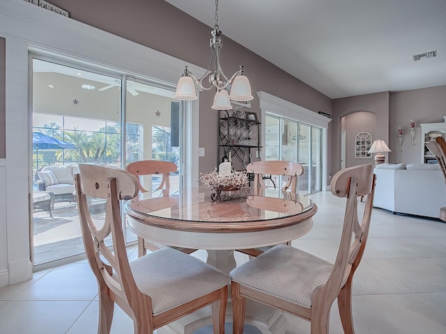 dining area with light tile patterned floors and a chandelier