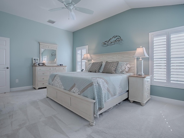 carpeted bedroom with ceiling fan and vaulted ceiling