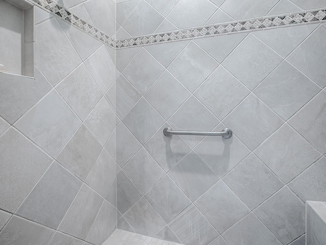 bathroom with a tile shower