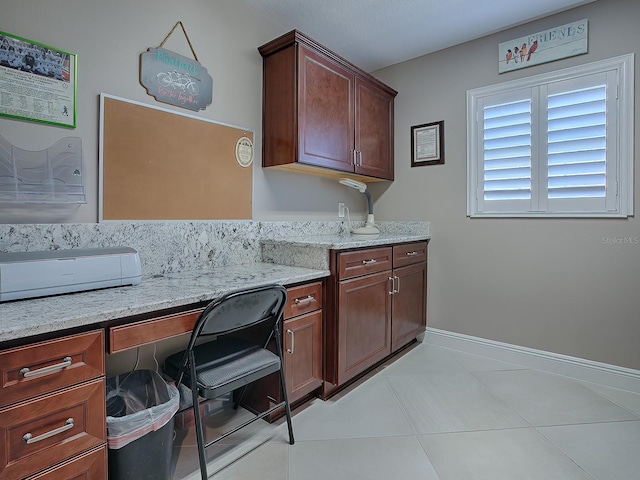 kitchen with light stone countertops and light tile patterned flooring