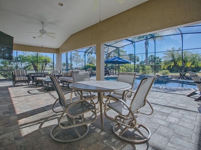 sunroom with ceiling fan, a swimming pool, and lofted ceiling