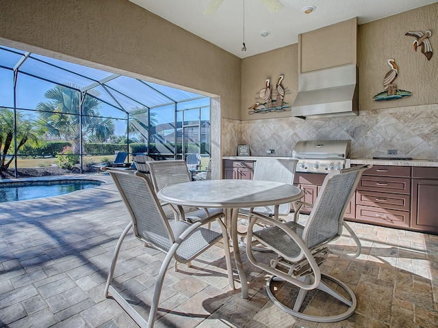 view of patio / terrace with area for grilling, a mountain view, and glass enclosure