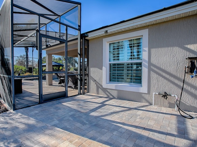 view of patio with a lanai