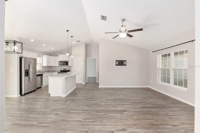 kitchen with white cabinetry, a center island, stainless steel appliances, light hardwood / wood-style flooring, and decorative light fixtures