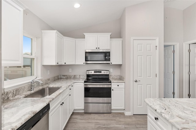 kitchen featuring stainless steel appliances, white cabinetry, and sink