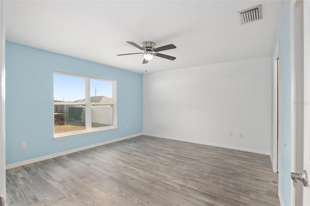 spare room with ceiling fan and light wood-type flooring