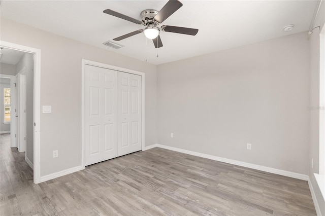 unfurnished bedroom with a closet, ceiling fan, and light hardwood / wood-style floors