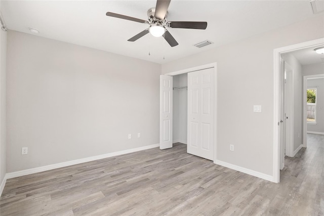 unfurnished bedroom with ceiling fan, a closet, and light hardwood / wood-style flooring