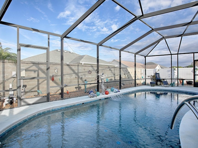 view of swimming pool featuring glass enclosure and a patio