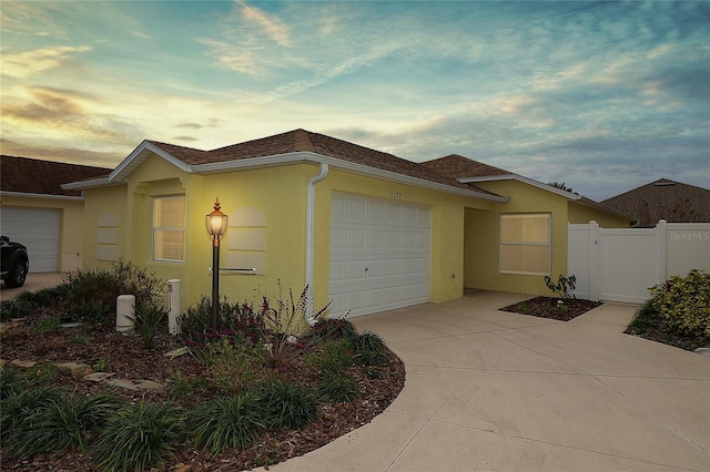 property exterior at dusk featuring a garage