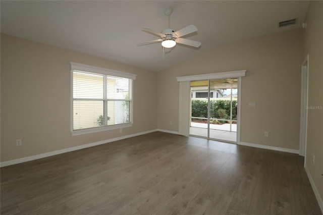 empty room featuring ceiling fan, dark hardwood / wood-style flooring, and vaulted ceiling