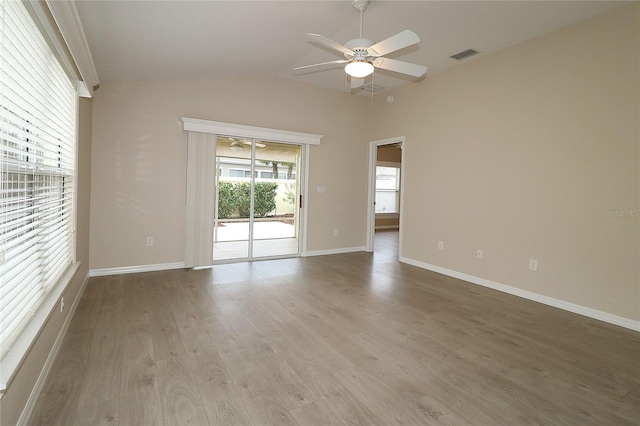 empty room featuring light hardwood / wood-style flooring, ceiling fan, and lofted ceiling