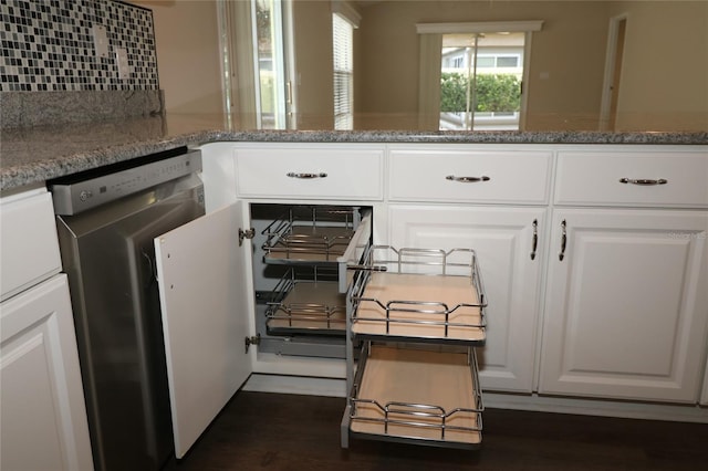 kitchen with white cabinets, dishwasher, decorative backsplash, and stone counters