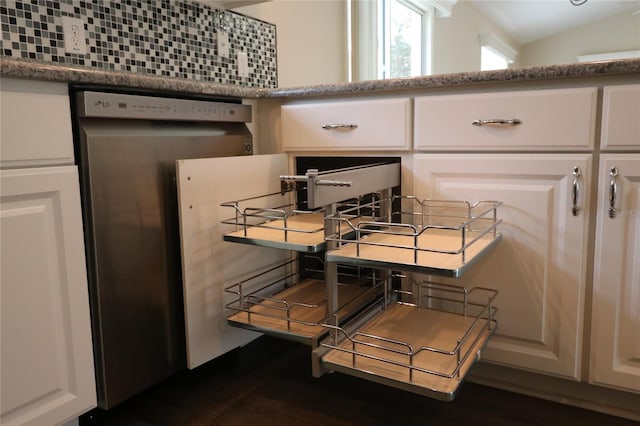 interior details featuring tasteful backsplash, white cabinetry, and stainless steel dishwasher