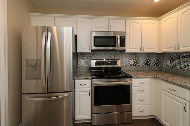 kitchen featuring tasteful backsplash, stone counters, white cabinetry, and stainless steel appliances