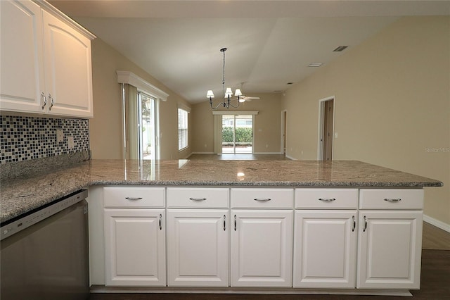 kitchen with stainless steel dishwasher, light stone counters, white cabinetry, and backsplash