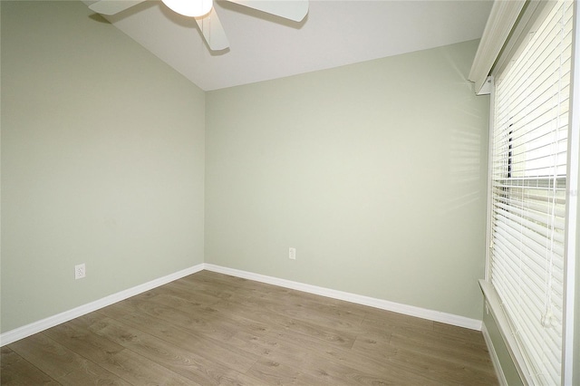 spare room featuring hardwood / wood-style flooring, ceiling fan, and lofted ceiling