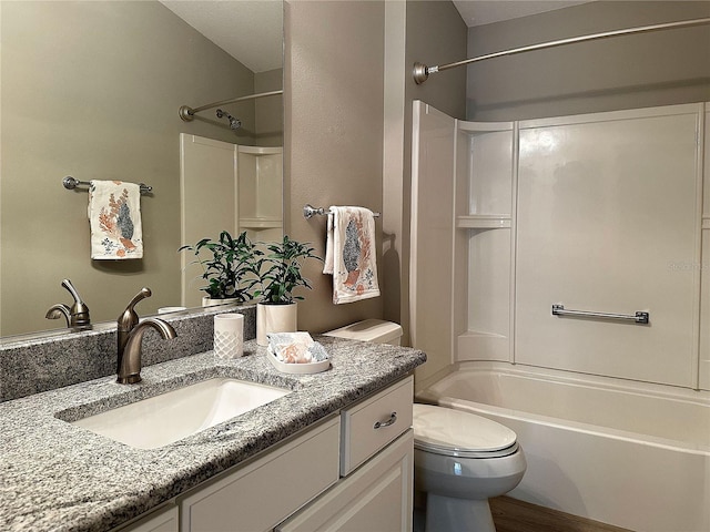 full bathroom featuring hardwood / wood-style floors, vanity, tub / shower combination, and toilet