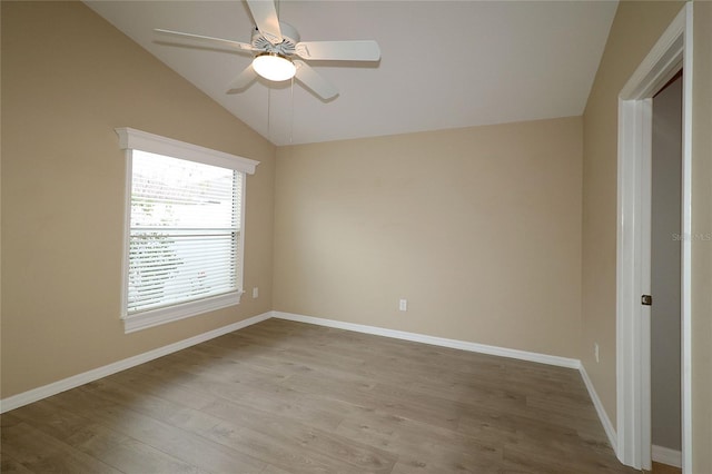 empty room with ceiling fan, light hardwood / wood-style flooring, and lofted ceiling