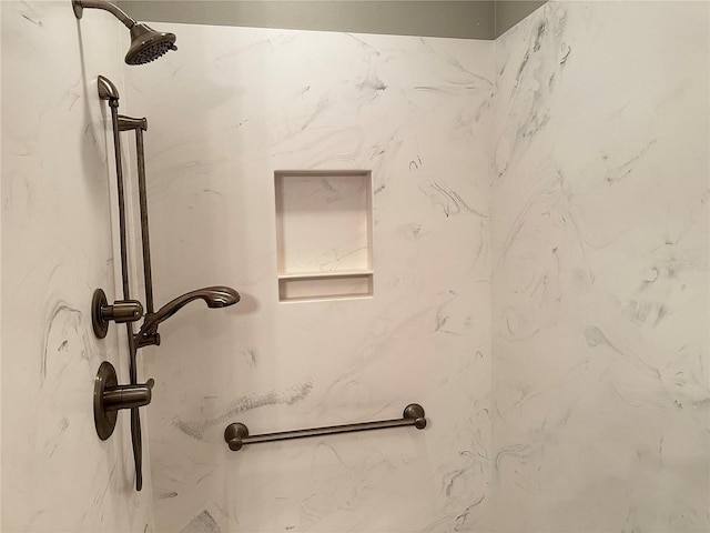 interior details with a tile shower