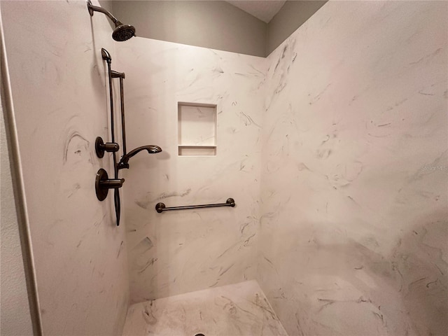 interior details with a tile shower