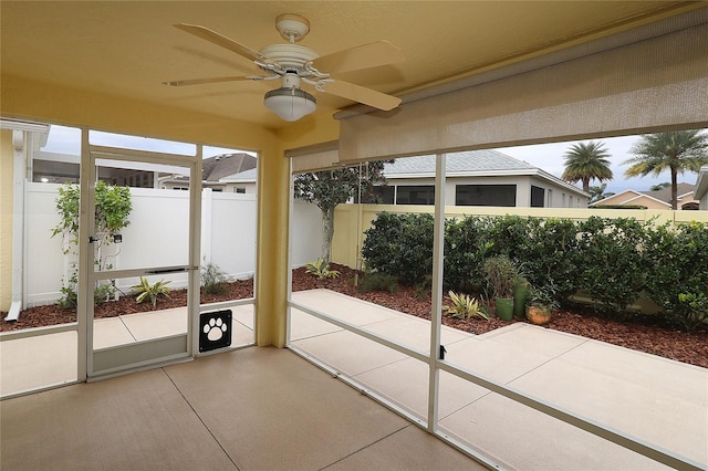 sunroom with ceiling fan and plenty of natural light