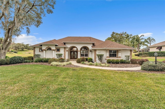 mediterranean / spanish-style home with french doors and a front yard