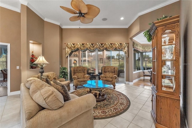 living room featuring ceiling fan, light tile patterned floors, and crown molding