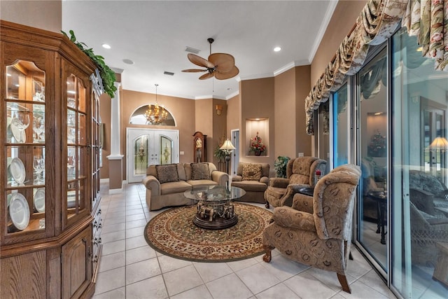 tiled living room with ceiling fan, french doors, a wealth of natural light, and ornamental molding