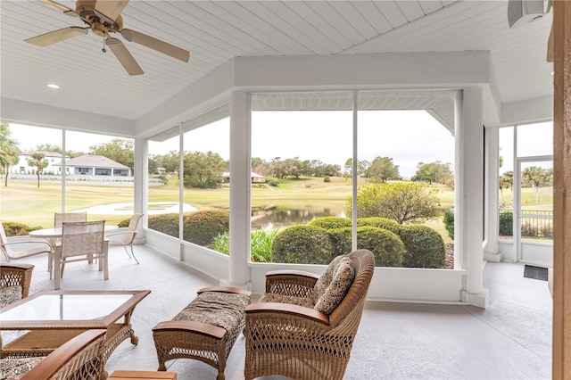 sunroom with ceiling fan, a wealth of natural light, wood ceiling, and a water view