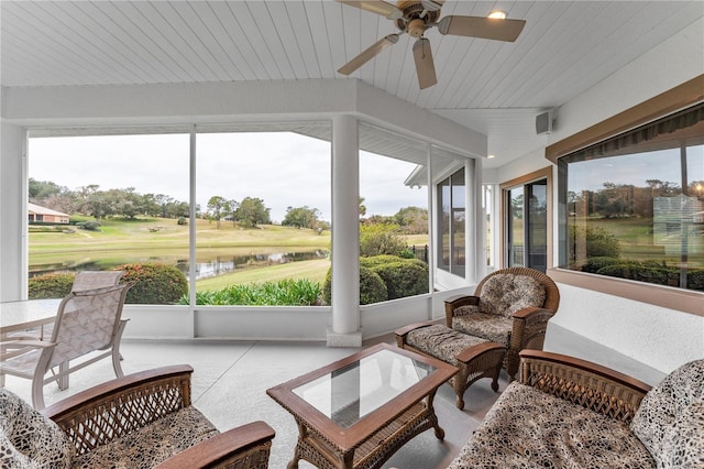 sunroom / solarium featuring ceiling fan, wooden ceiling, and a water view