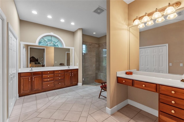 bathroom with vanity, tile patterned flooring, and a shower with door