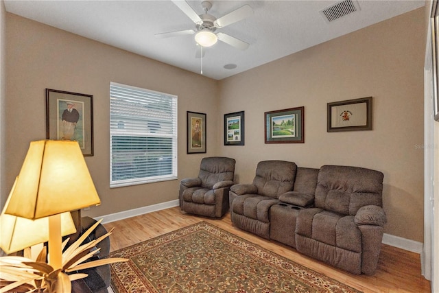 living room featuring ceiling fan and wood-type flooring