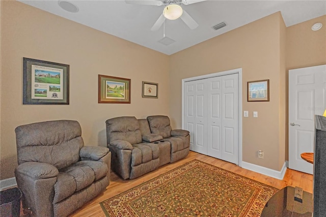 living room with ceiling fan and wood-type flooring