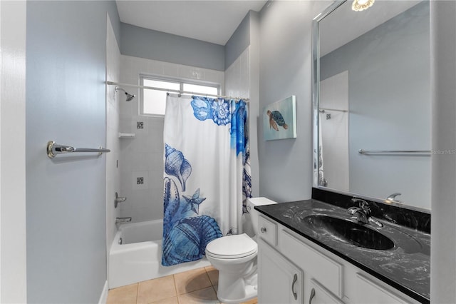 full bathroom featuring toilet, tile patterned floors, vanity, and shower / bath combo with shower curtain