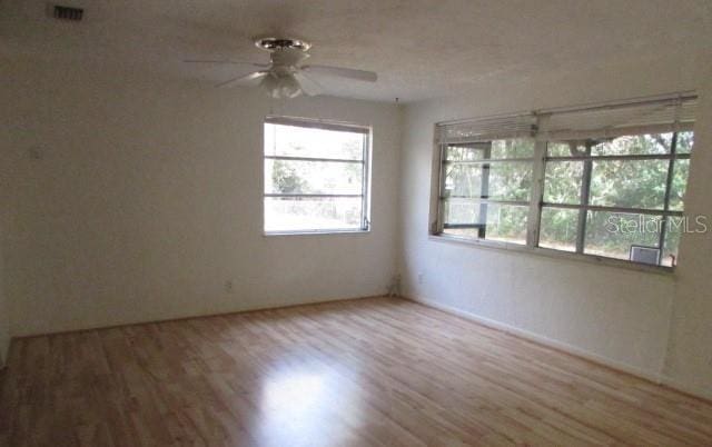 spare room with wood-type flooring and ceiling fan