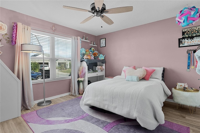 bedroom with ceiling fan and light wood-type flooring