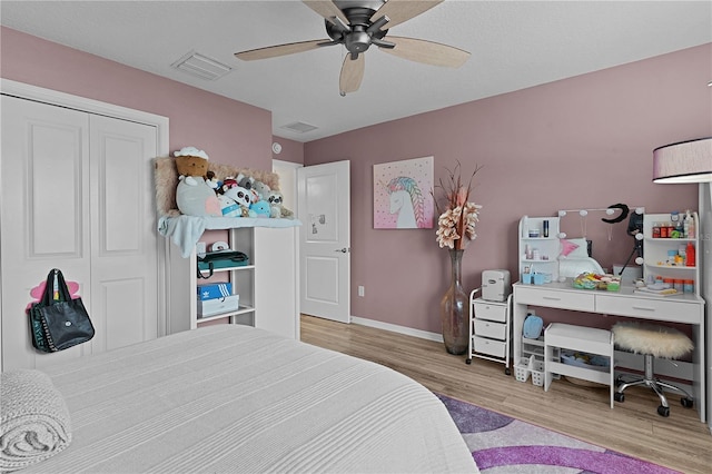 bedroom featuring ceiling fan, light wood-type flooring, and a closet