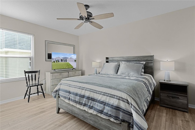 bedroom with light wood-type flooring and ceiling fan